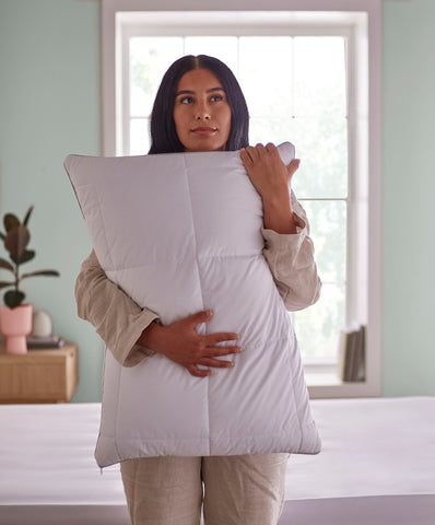 holding a latex pillow