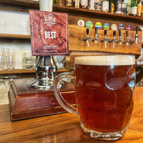 Pint of Best Bitter next to a traditional hand pull