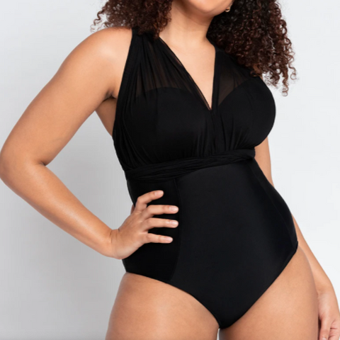 Woman wearing black strapless swimsuit with sheer scarf-style wraps that she's used to create a halter top.