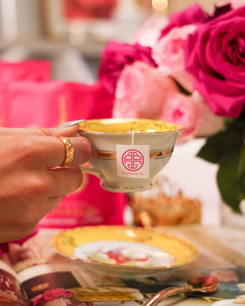 Woman Holding Yellow Tea Cup Filled with BuDhaGirl Organic Tea | BuDhaGirl Teas and Tisanes