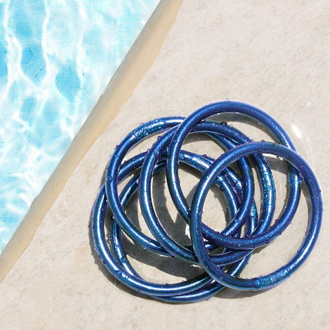 Marine All Weather Bangle next to a pool