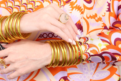 Woman wearing Gold All Weather Bangles and a Diva Ring