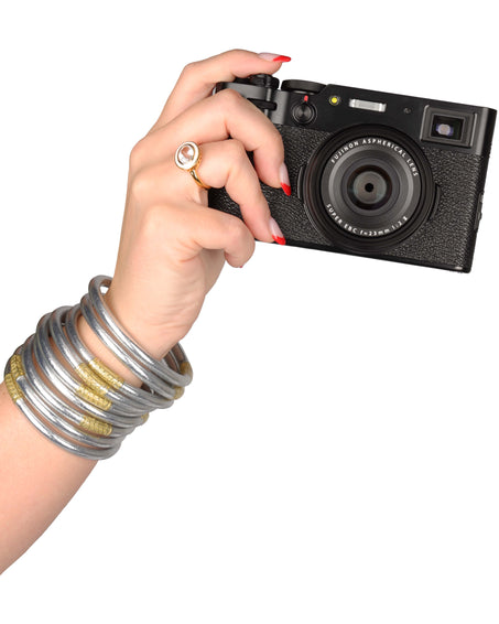 Model wearing Silver All Weather Bangles and holding a Camera | BuDhaBrief by BuDhaGirl