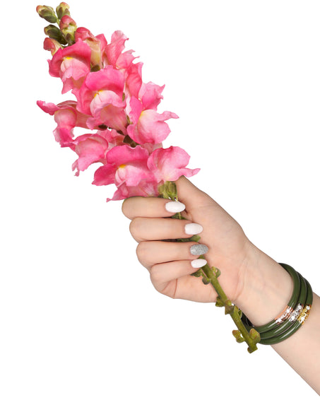 Model wearing Jade Three Kings All Weather Bangles while holding pink snapdragon flowers | BuDhaBrief by BuDhaGirl