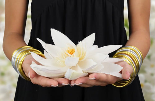 Lotus held on hands wearing BuDhaGirl All Weather Bangles | BuDhaGirl