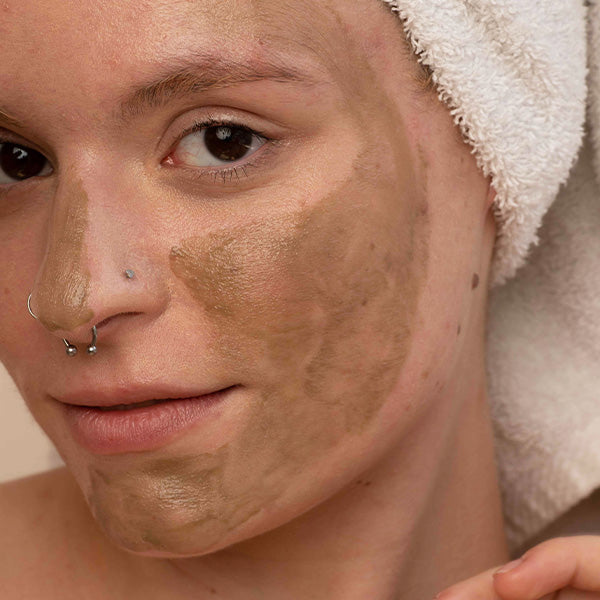 woman using a mask to regain her glowing skin.