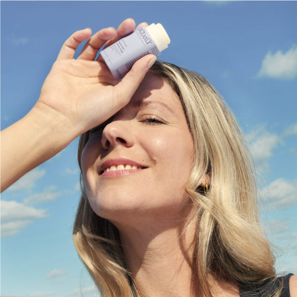 blond hair middle-age woman hanging her Phyto-Age product Oceanly ATTITUDE