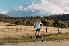 Triathlete running in Victorian countryside