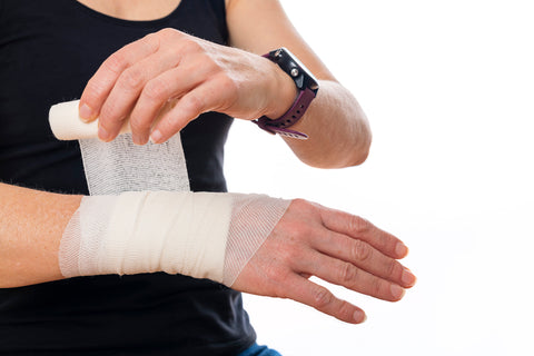 image of cyclist wrapping wrist to prevent wrist pain