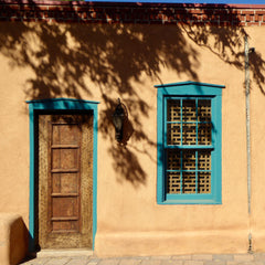 Adobe house with turquoise window and door frames - photo by Matt Briney