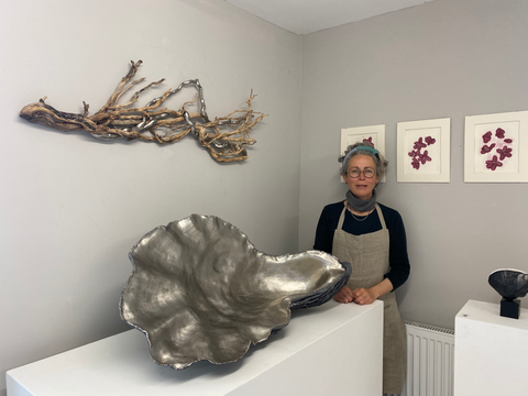 Lucy Gray at her studio beside her sculpture 'Shell IV'