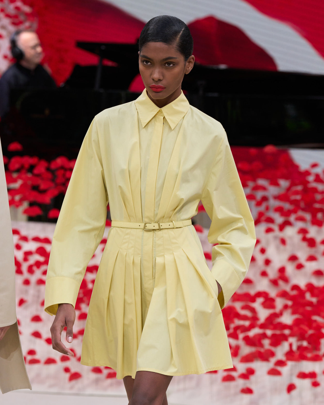 Model in a pastel yellow shirt dress on the Paris runway by Akris