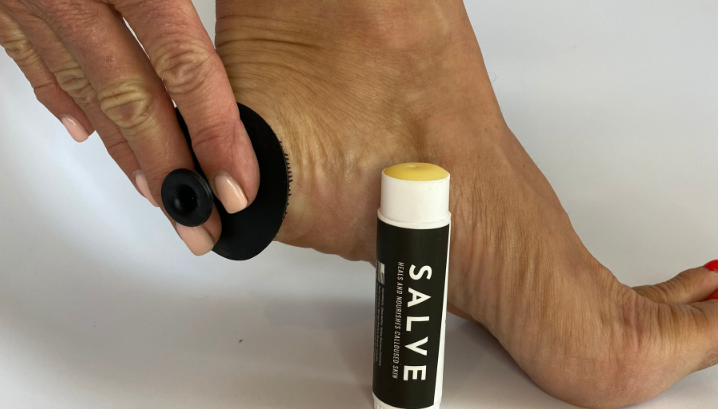 Heel being scrubbed and moisturized with SandBar Salve