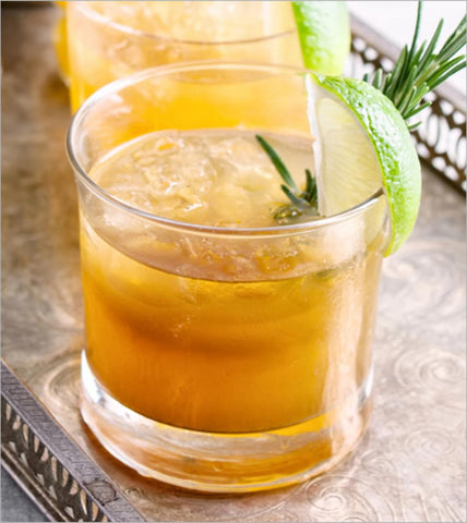 Chilly Moose Canadian Cocktail Ideas. Clear glass filled with ice, an amber coloured cocktail, and a lime wheel garnish. Cocktail adapted from Crown Royal.ca