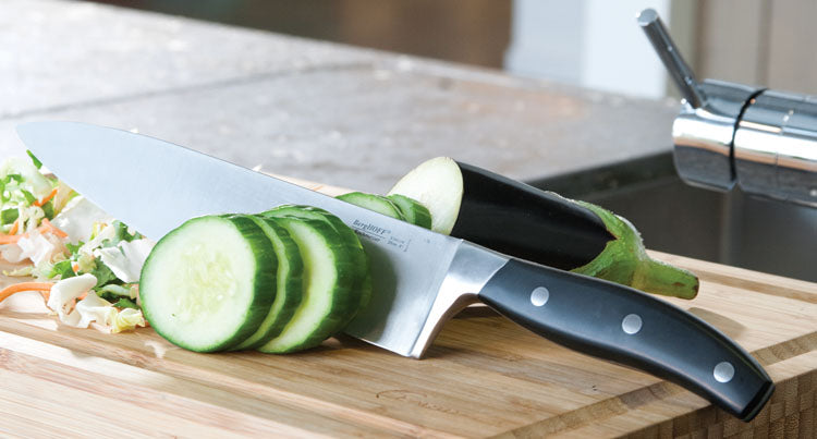 Chef's knife slicing cucumber