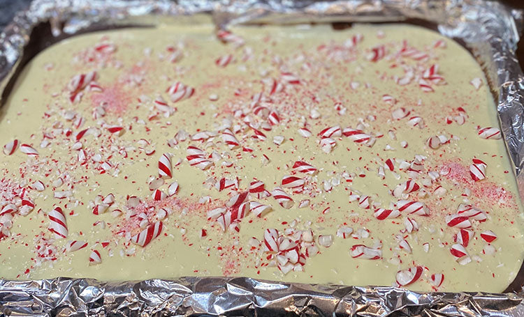 Press peppermint candy into white chocolate.