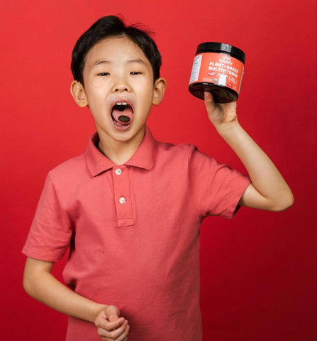 Little boy taking a Llama Naturals Plant-Based Multivitamin