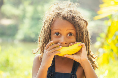 Kid eating a banana