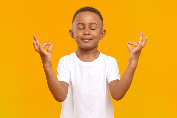 Magnesium for kids: little boy meditating
