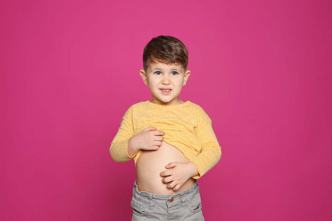 Gut health for kids: little boy scratching his stomach