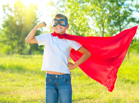 Vitamin D for kids: little boy wearing a mask and a red cape