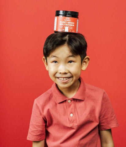 Little boy with a jar or Llama Naturals on his head