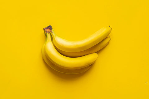 B complex for stress: ripe bananas on a yellow background