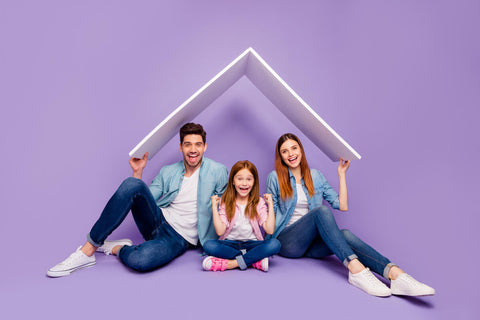 Family smiling with purple background