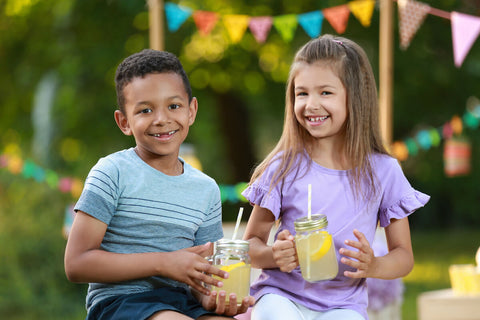 Vitamin C for kids: kids each holding a glass of lemonade