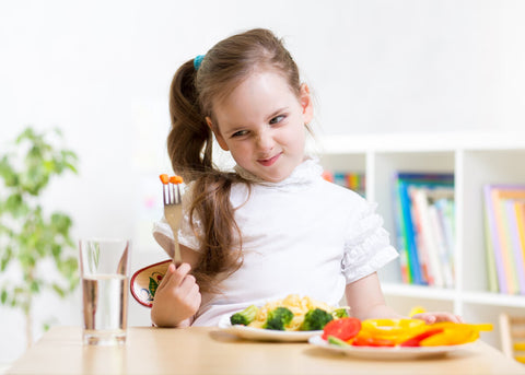 Picky eater food list: little girl looking at her healthy food