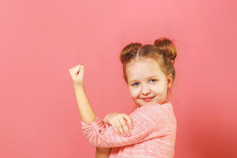 Vitamin D vs D3: little girl flexing her bicep