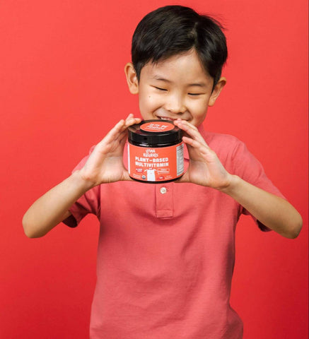 Little boy happy holding a jar of Llama Naturals