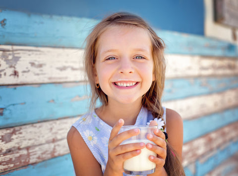 Girl happily drinking milk