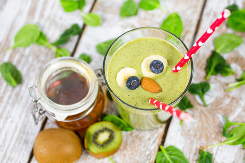 Healthy smoothie with a cute face made from berries and nuts