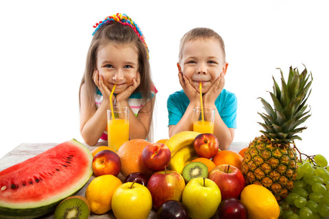 Best vitamins for kids: kids drinking fruit juice