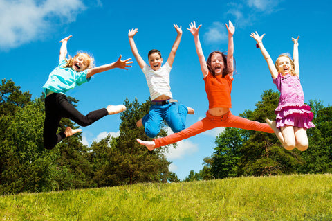 Biotin for kids: kids jumping outdoors