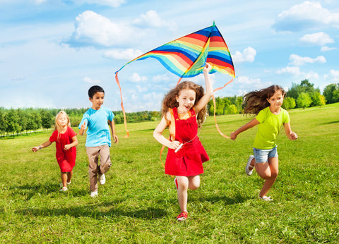 Biotin for kids: kids running while trying to fly a kite
