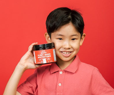 Little boy holding a jar of Llama Naturals