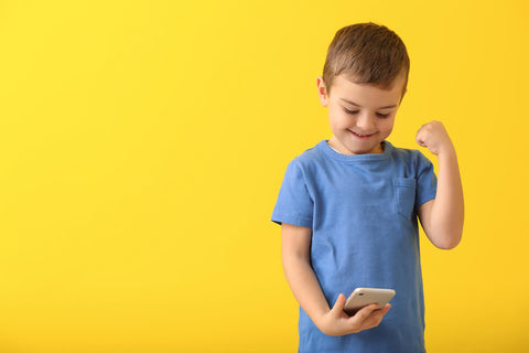 Little boy playing a game on his phone