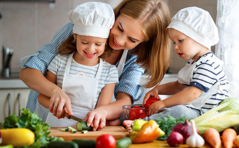 Mom preparing vegetables with her children