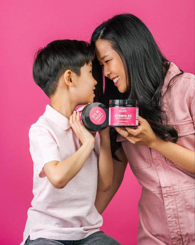 Mother and son each holding a jar of Llama Naturals