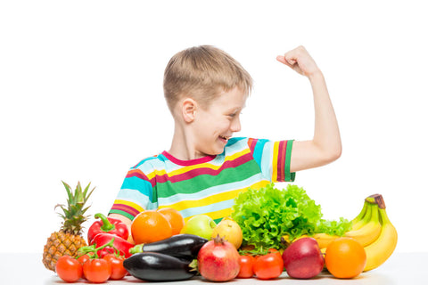 Picky eater food list: strong little boy in front of fruits and vegetables