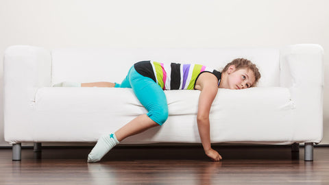 Iron supplement for kids: tired kid lying down on the couch