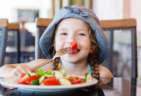 Nutrients for kids: toddler eating vegetables