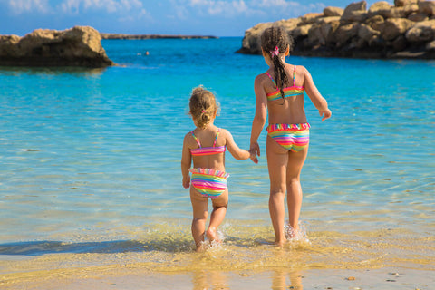 Two little girls walking by the beach