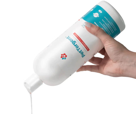 A bottle of petergent pet safe detergent being poured out