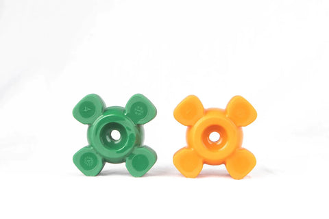Two "x" shaped rubber dog toys sit up in a white background. They have round centers with a hold in the middle.