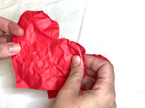Crumpling and smoothing the paper hearts