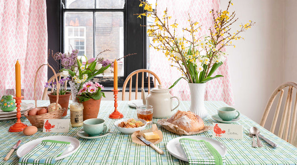 An Easter table with Molly Mahon's Trellis Green table cloth, spring flowers, napkins to match and hand block printed name placings. Cute!