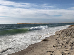 White capped waves crashing on sandy shoreline at Cape Cod National Seashore